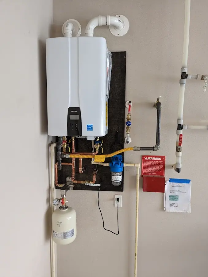 Professional plumber installing copper piping in a Beacon Falls home